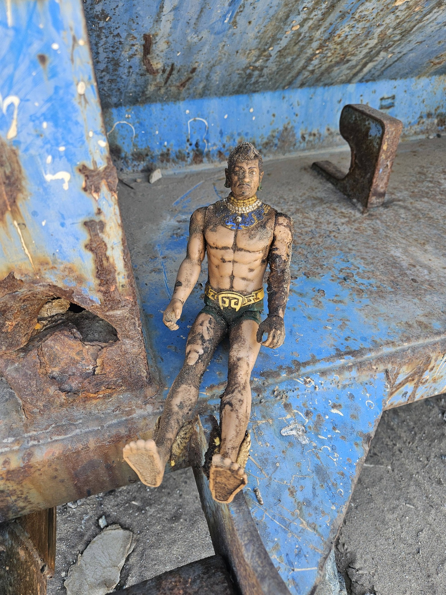 A muddy action figure recovered from the trash haul